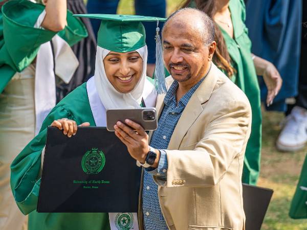 A family taking a photo at commencement