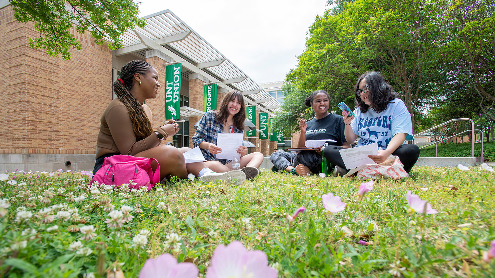 Students sitting on the lawn outside of the UNT Student Union