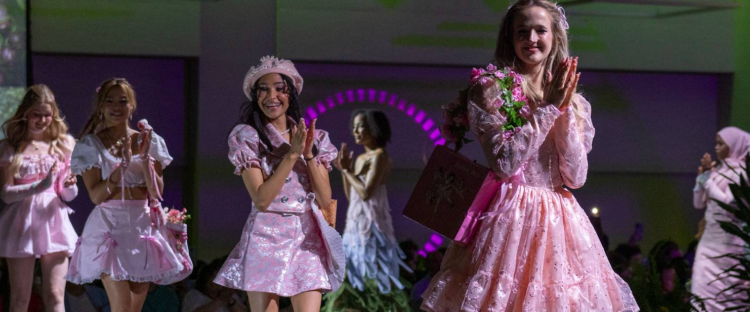 Models wearing a collection of dresses on a catwalk