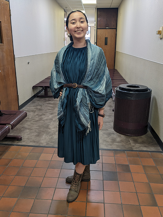 Yumi Standlee poses in the Linguistics Building hallway