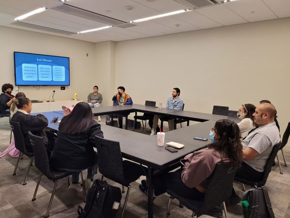 students sitting at a round table for a meeting 