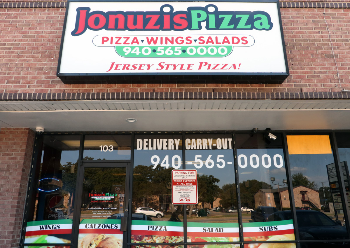 Jonuzi's pizza sign and front entrance 