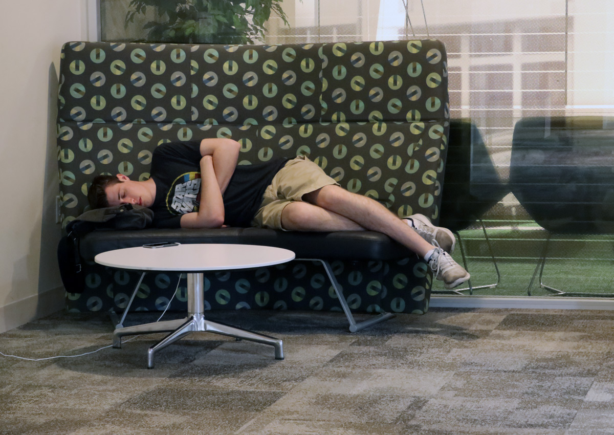 Student napping on a booth located on Union's fourth floor